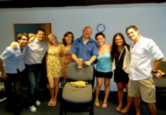 man with students smiling in classroom