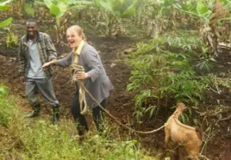 Michelle delivering the goat she bought for the farmer