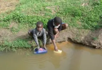 The kids were drinking stagnant water from a dirty pond