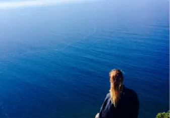 woman looking at the ocean