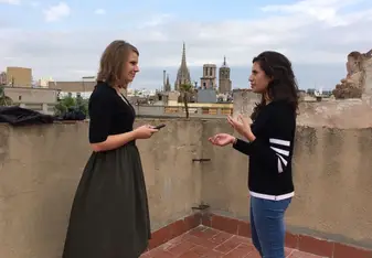 two girls talking on a rooftop Plaça Reial barcelona