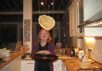 woman flipping crepe