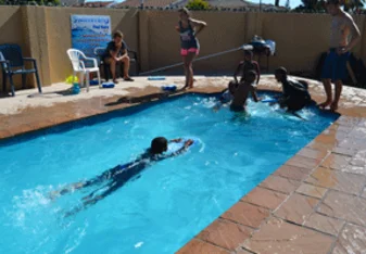 Swimming lessons in the pool by our house!