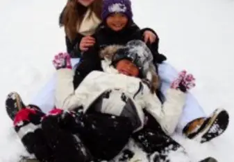 Hannah sledding with her host sisters – Olivia and Mei Mei.