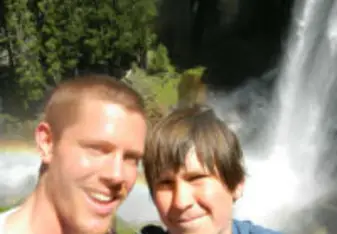 two boys above waterfall rainbow