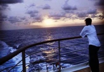 girl on a ship at sunset