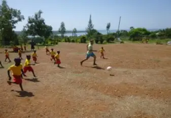 KVCDP volunteers play football after building goal posts for the kids. 