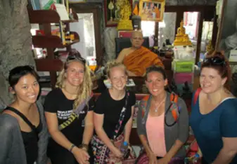 Maegan with friends and a monk