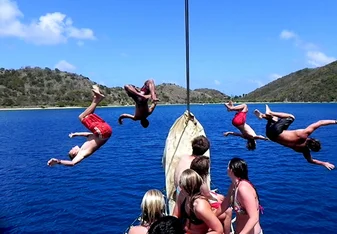 people jumping off boats
