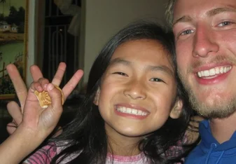 volunteer smiling with girl