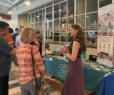Counselor speaking to a parent at booth at Gap Year Fair