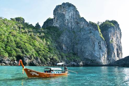 A boat in light blue waters of Thailand