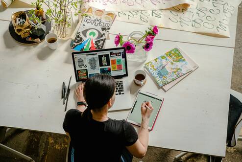Person at desk working at laptop