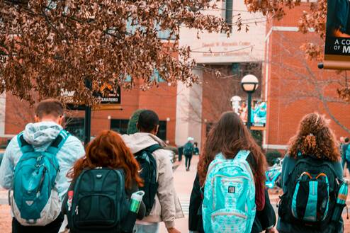 Students walking to school showing their backpacks