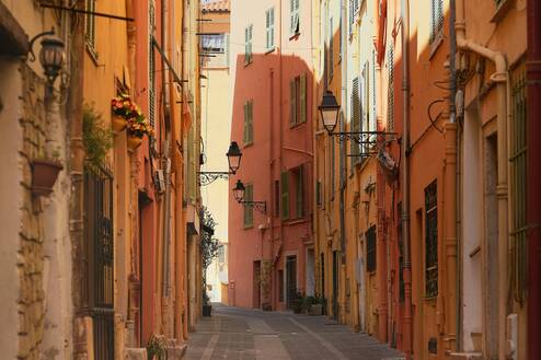 A narrow city street lined with tall buildings