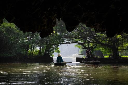 A person on a small raft in a river in Asia