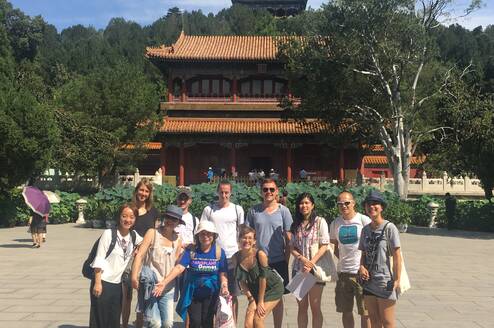 group in front of chinese building