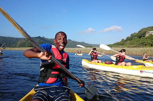 Male student on a kayak living his best life in Cape Town 