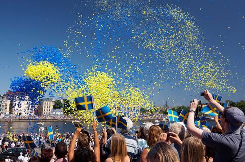 swedish festival with balloons in the air and people celebrating