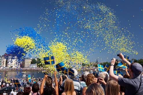 swedish festival with balloons in the air and people celebrating