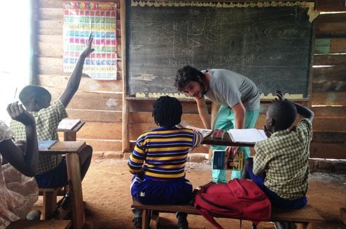 Volunteer teacher in Ugandan classroom