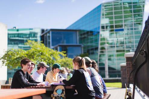 Students on campus outside a cafe