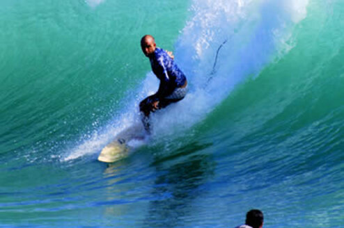Learn Spanish & Surf in Panama's Caribbean, in Bocas del Toro person surfing catching a big wave
