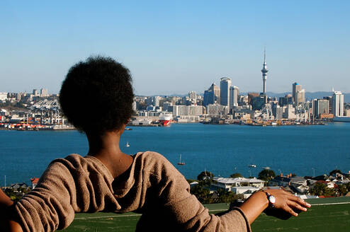 A student visiting Mount Victoria in Devonport, Auckland, looking at Auckland CBD's skyline