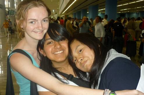 American intern hugging Mexican friends
