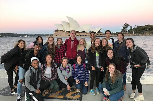 Students striking a pose in front of the famous Sydney Opera House.