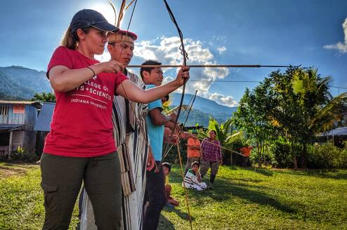 Professor Julie Madewell from Indiana University shoots and bow and arrow