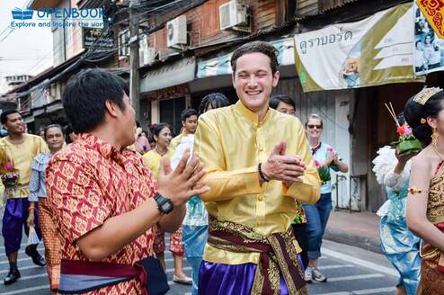 Teacher and student laugh in a street festival