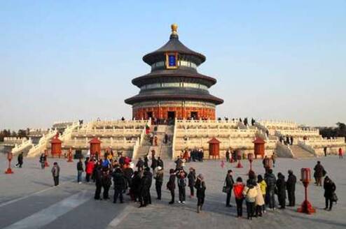 crowd of people standing in front of Chinese temple with 