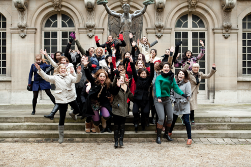 Group of students jumping during trip to Paris