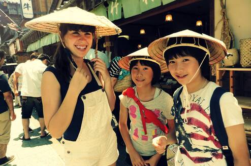 American girl with Japanese host sisters wearing traditional hats