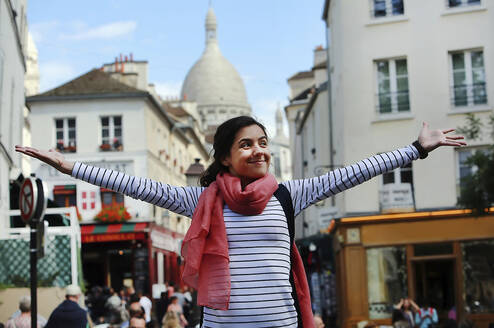 Girl with arms outstretched, taking in the beauty of France