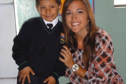 Volunteer with her student after culminating a teaching English program.