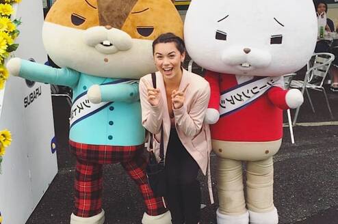 Canadian poses with characters on a Japan working holiday