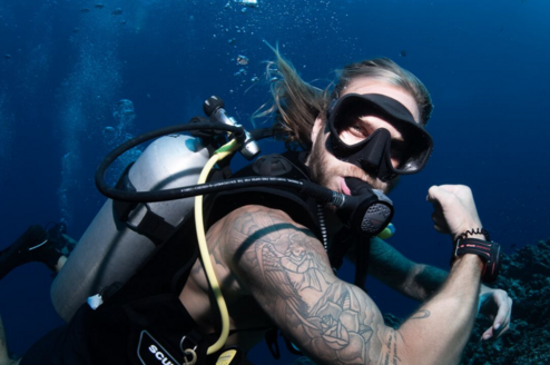 Scuba diver flexing his muscles underwater