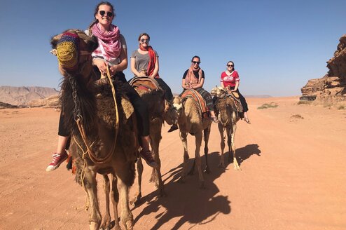 Students exploring the Wadi Rum desert by camel