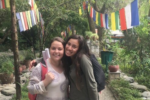 Two participants outside a temple