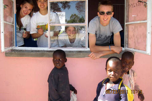 Volunteers look out from classroom