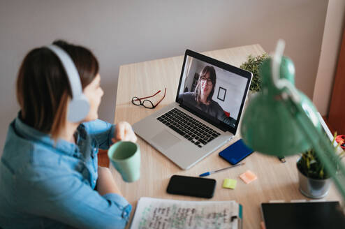 Young woman learning on laptop
