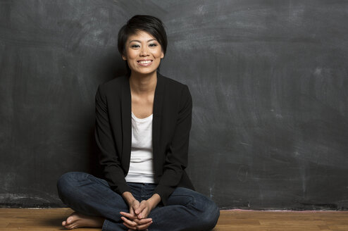 Teacher in Hong Kong in front of a blackboard
