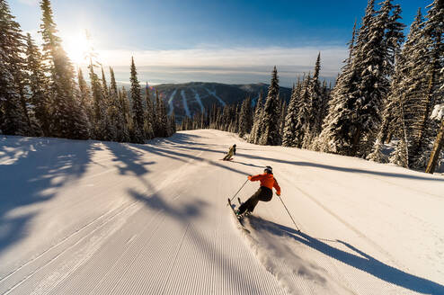 Skier on morning run, empty slopes