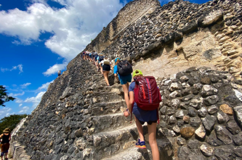 Students climb up the steps at the Mayan ruins at Xunantunich.