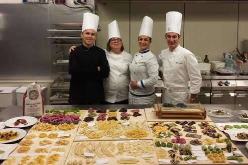 Four chefs in a kitchen.