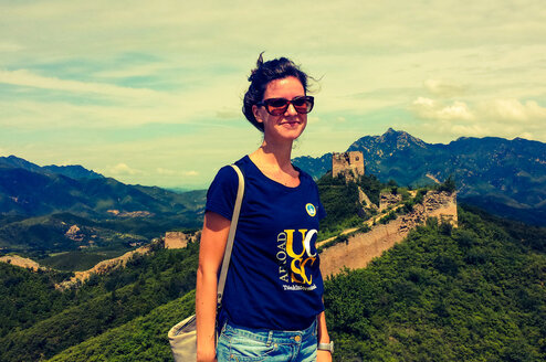 Woman standing in front of The Great Wall of China.