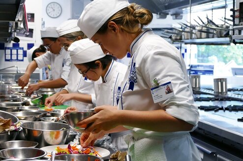 Students in the kitchen during Cuisine Diploma program at Le Cordon Bleu