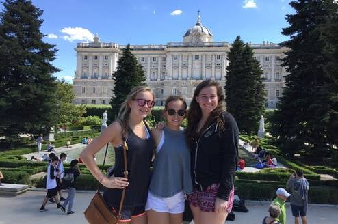 3 Horizons Abroad teen Spanish immersion students smiling in front of Madrid's Royal Palace